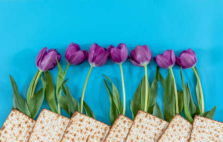 Matzos and flowers on the blue background. Passover (Pesach) Sederの写真素材