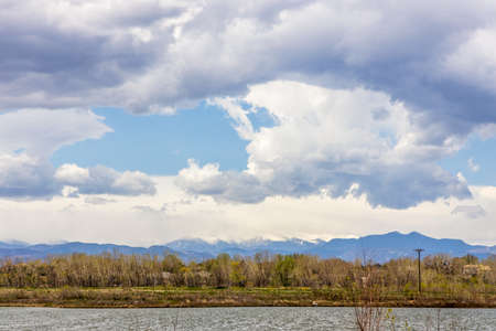 Colorado landscape near Brighton, Colorado. Small pond and grass with the Long Peek view in the distanceの写真素材