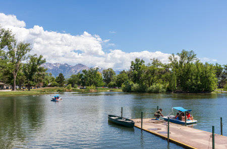 Salt Lake City, Utah - May 31, 2021: The pond with a boat pier in Liberty Park in downtown Salt Lake City, Utah. People riding on the pedal boatsのeditorial素材