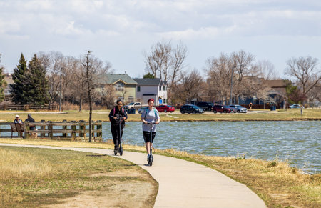 Denver, Colorado - April 17, 2022: Mother and daughter riding on the electric scooter in Lake Arbor Park, Denver, Coloradoのeditorial素材