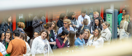 Dublin, Ireland - June 2, 2022: People on the bus station seen from the top of a tourist bus in...