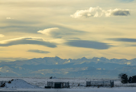 The Natural Beauty of Winter in Frederic, Colorado. Fence, shacks, and pumpjacks on the foregroundの写真素材