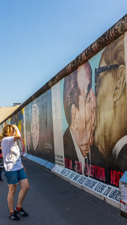 Berlin, Germany - June 1, 2023: Tourists visiting free public urban art of East Side Gallery on a public street in Berlin, Germanyのeditorial素材