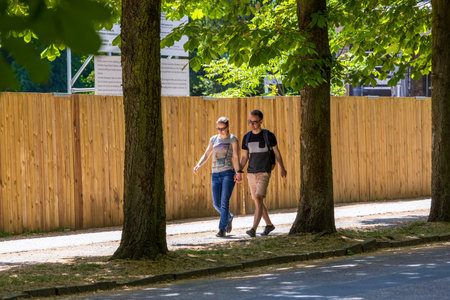 Potsdam, Germany - June 3, 2023: Sanssouci palace and park in spring, in Potsdam, Brandenburg, Germany. A couple walking in the alleyのeditorial素材
