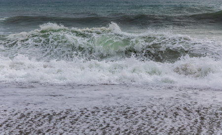 Big crashing waves in a stormy ocean. South Island, New Zealand