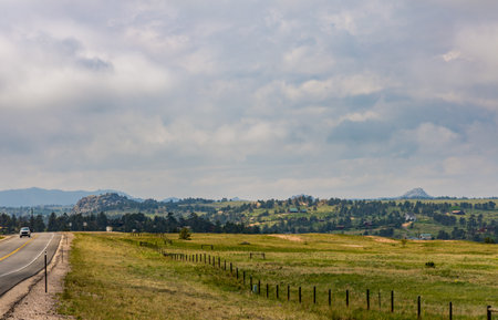Rural Wyoming landscape with the country road in Cheyenne, Wyomingの写真素材