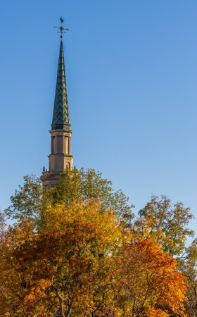 Beautiful fall foliage and the spire of the First Baptist Church of Denver in downtown Denver, Coloradoの写真素材