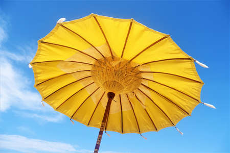traditional yellow beach umbrella or parasol or sunshade in Lombokの写真素材