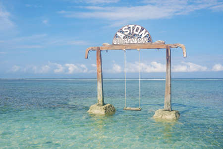 LOMBOK, INDONESIA - OCT 23, 2020: Beach swing in the coastline of Aston Sunset Beach Resort, Gili Trawangan, Lombokのeditorial素材
