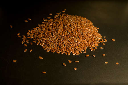 Flax seeds in a dark backgroundの写真素材