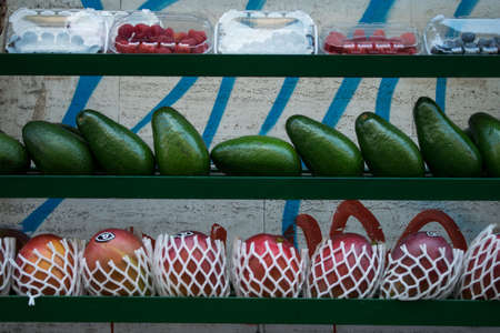 Various fruits in a shop, avocado, mango, red fruitsの写真素材
