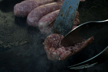 Doing bbq grill sausage cooking raw meat