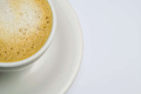 A cup of coffee and milk disposed on a white backgroundの写真素材