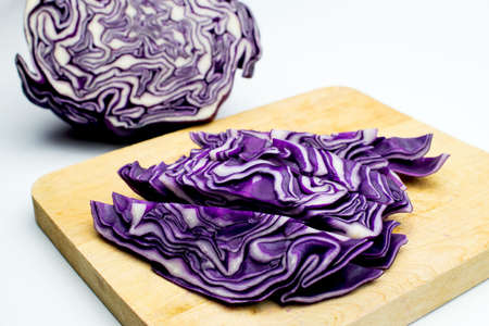 A portion of a red cabbage disposed on a white backgroundの写真素材