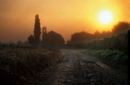 Dawn in Tuscany with churchの写真素材