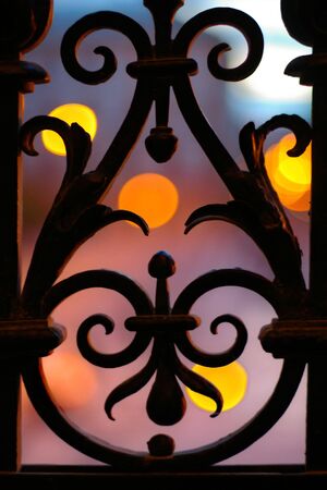 Wrought iron fence detail at nightの写真素材