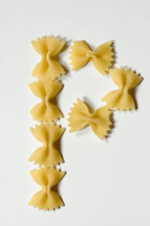 Letter P written with farfalle pasta on white backgroundの写真素材
