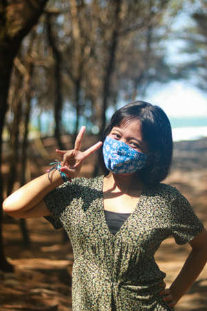 Outdoor lifestyle portrait of beautiful young asian woman on the beach.