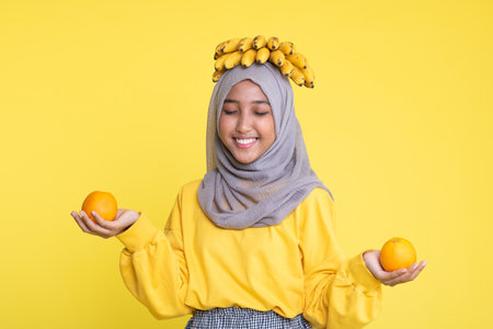 woman making fun with a banana isolated on yellow background.