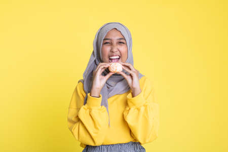 woman with orange on yellow background.