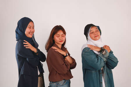 Fashion portrait of three best friends posing in studio