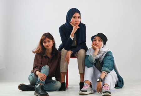 Fashion portrait of three best friends posing in studioの写真素材