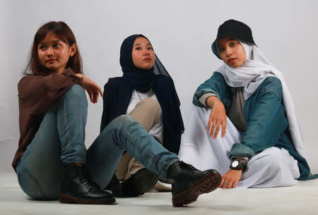 Fashion portrait of three best friends posing in studioの写真素材