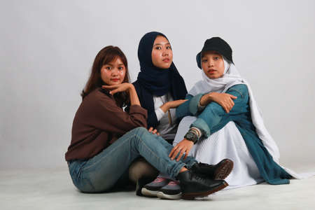 Fashion portrait of three best friends posing in studioの写真素材