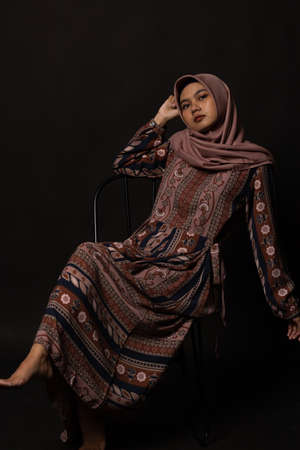 Fashion portrait of young beautiful asian muslim woman with wearing hijab on black background