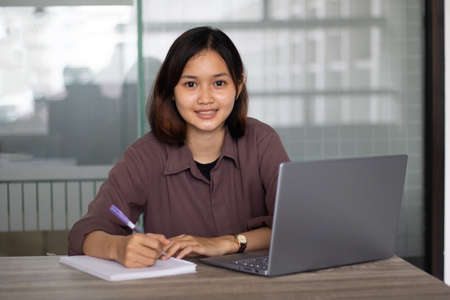 Portrait of beautiful young woman working in the office.