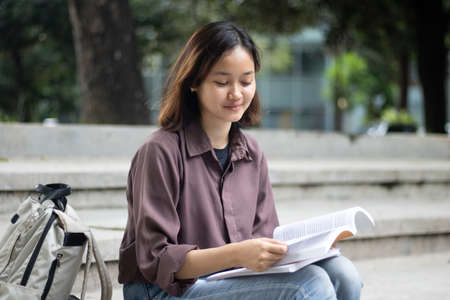 Young woman studying at the park.の写真素材