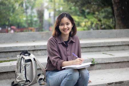 Young woman studying at the park.の写真素材