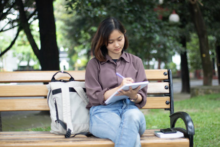 Young woman studying at the park.の写真素材