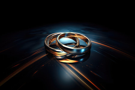 Sacrament: Matrimony. Wedding rings on a dark backgroundの素材