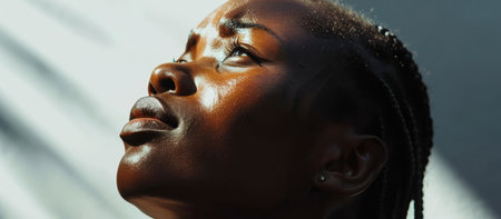 Touched by His Grace. Beautiful young black woman with braids looking up with tears in her eyes. Christian conceptの素材
