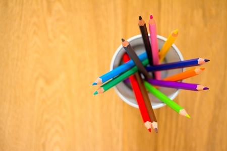 a shot of some colourful pencils on wood backgroundの写真素材