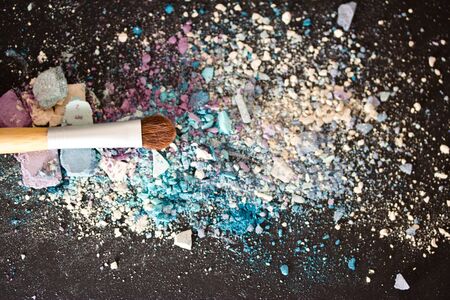 a still-life of colourful eyeshadow powder and make-up brushの写真素材