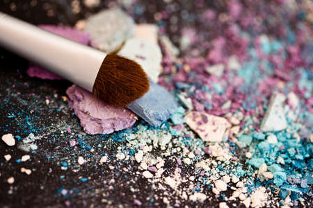 a still-life of colourful eyeshadow powder and make-up brushの写真素材