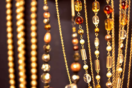 a set of golden necklaces shot at shallow depth of field on blackの写真素材