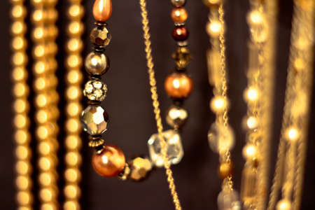 a set of golden necklaces shot at shallow depth of field on blackの写真素材