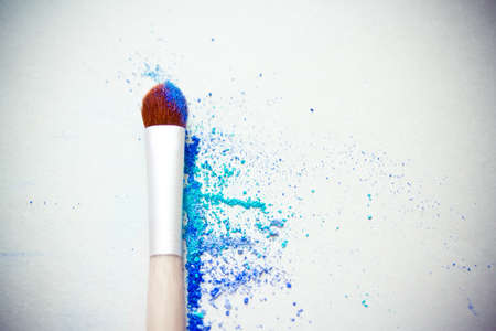 a still-life of colourful eyeshadow powder and make-up brushの写真素材