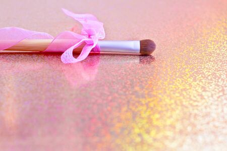 eyeshadow brush with pink ribbon, shallow depth of fieldの写真素材