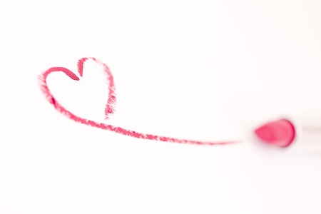 lipstick drawing a heart mark on whiteの写真素材