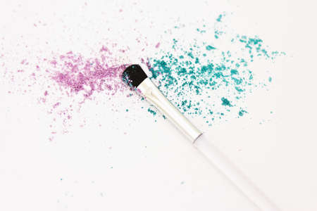 a still-life of colourful eyeshadow powder and make-up brushの写真素材