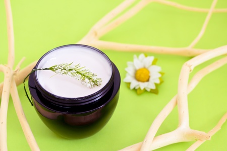 concept of organic cosmetics, beauty product with flower and branchesの写真素材