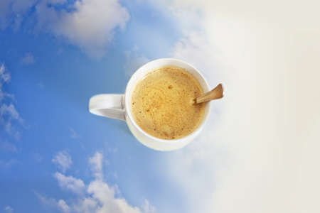 cup of coffee on white table with sky gradientの写真素材