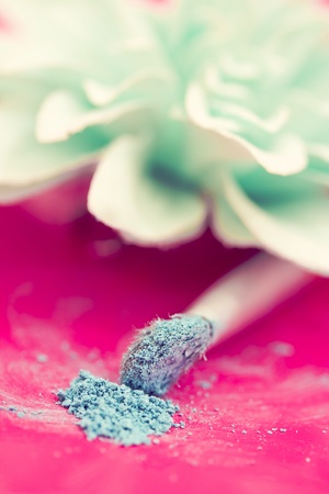 close-up shot of make-up brush with blue eyeshadow powderの写真素材