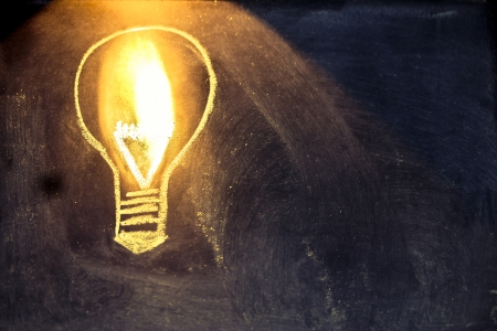 lighbulb design on blackboard, metaphor of innovationの写真素材