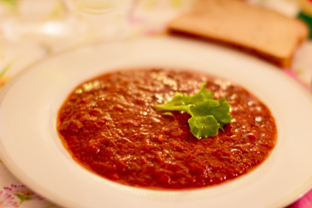 a dish of bolognaise sauce with beef, tomatos, onion and basil