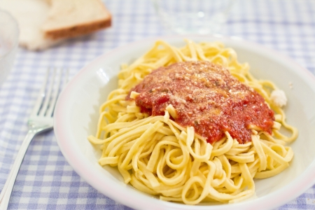 detail of dinner table with a pasta and tomato recipeの写真素材